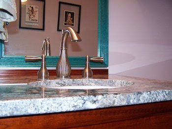 New vanity with fixtures and granite top after powder room renovation.