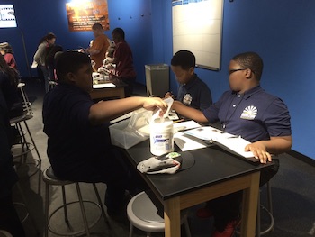 Black school children documenting their research results.