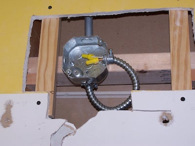 The conduit affixed to the electrical box.