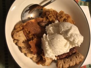 Slice of sweet potato pie with ice cream.