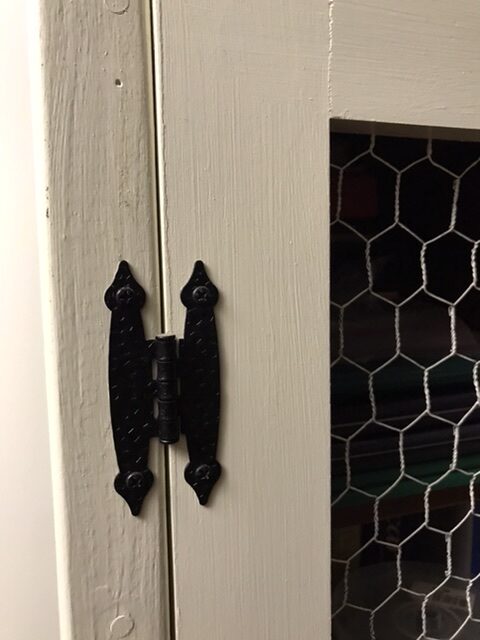 Black hinge on the bookcase.