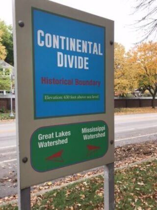 Continental divide street marker symbolizing growth and division.