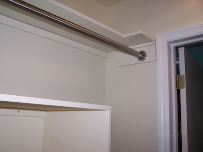 The shelf and pole installed over the  hanging wall chest.