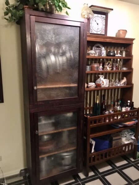 The pot rack and backers rack side by side in the kitchen.