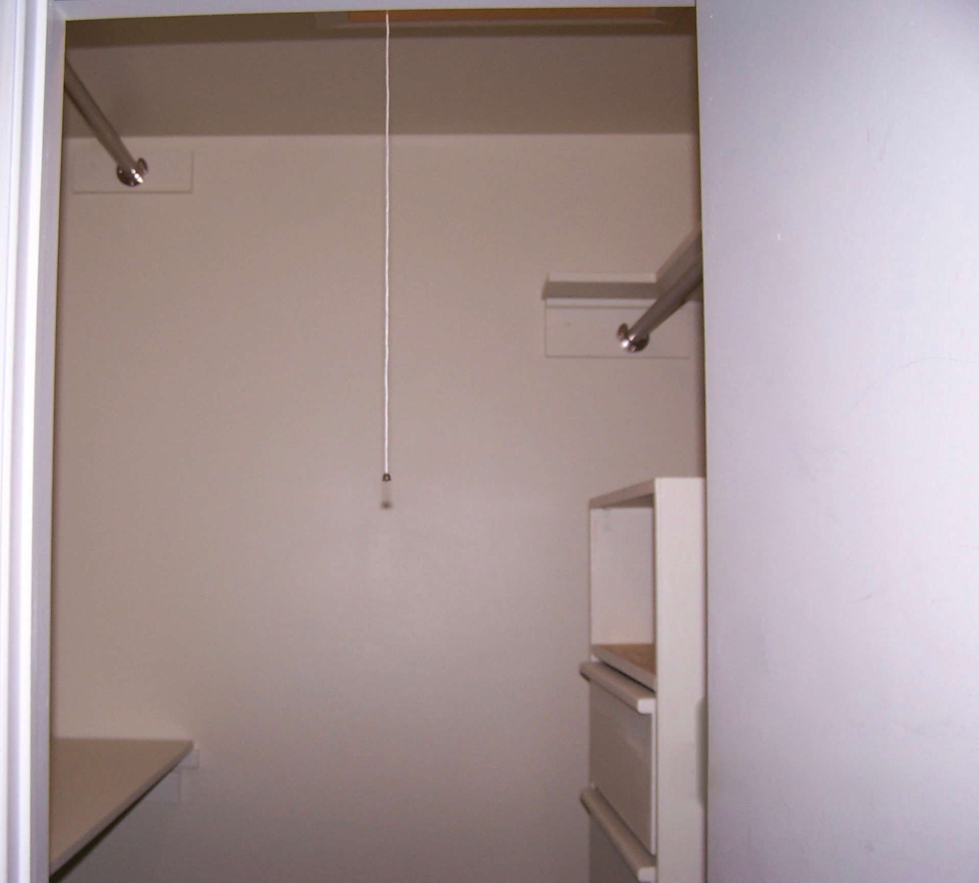View of the hanging wall chest, closet poles, and shelves.